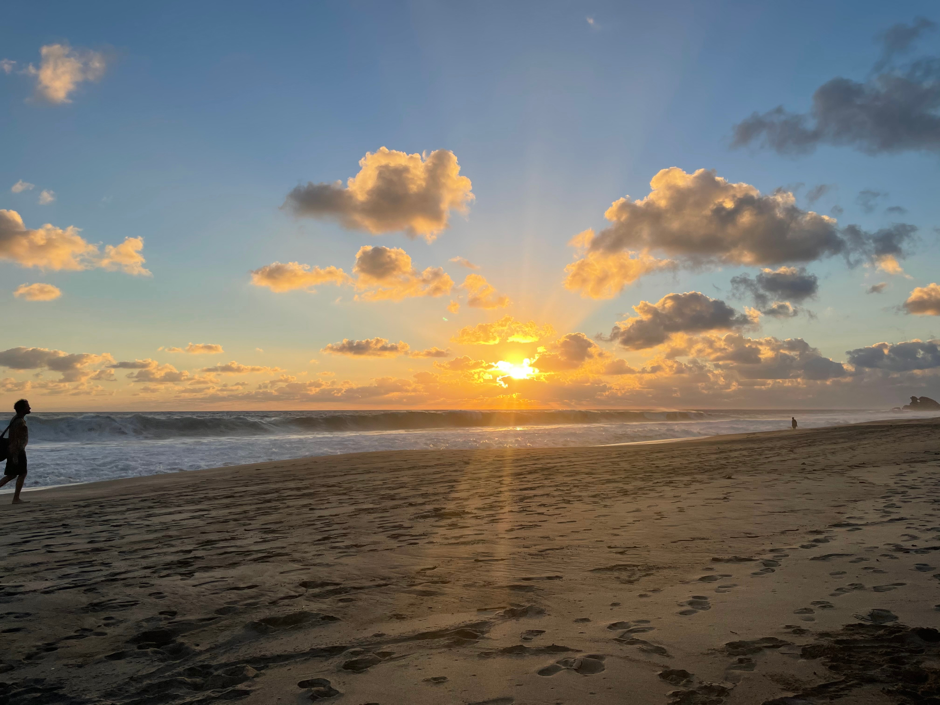 Sunset over the Pacific with breaking waves